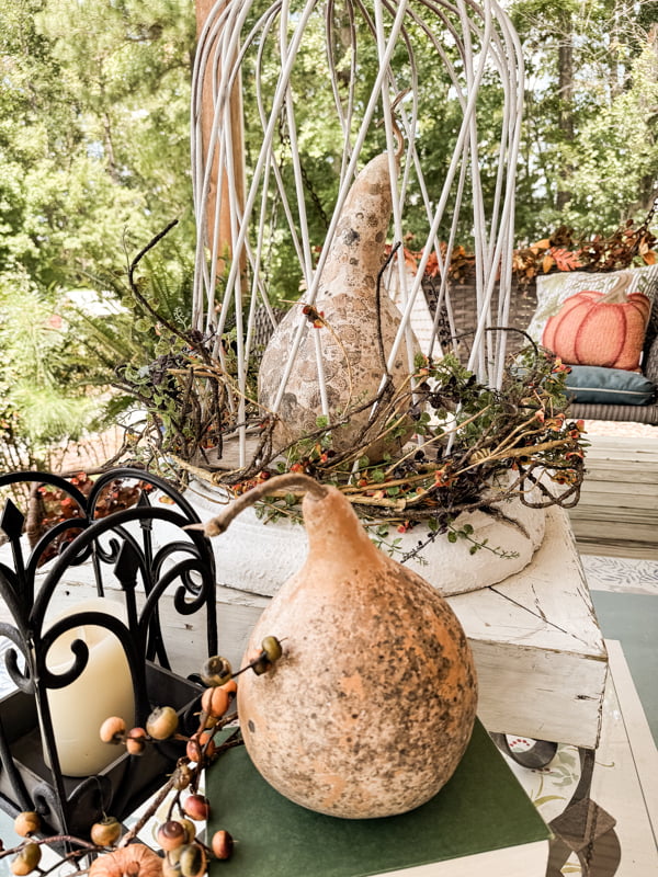 Coffee Table centerpiece with architectural column base and metal cloche over a dried gourd.  