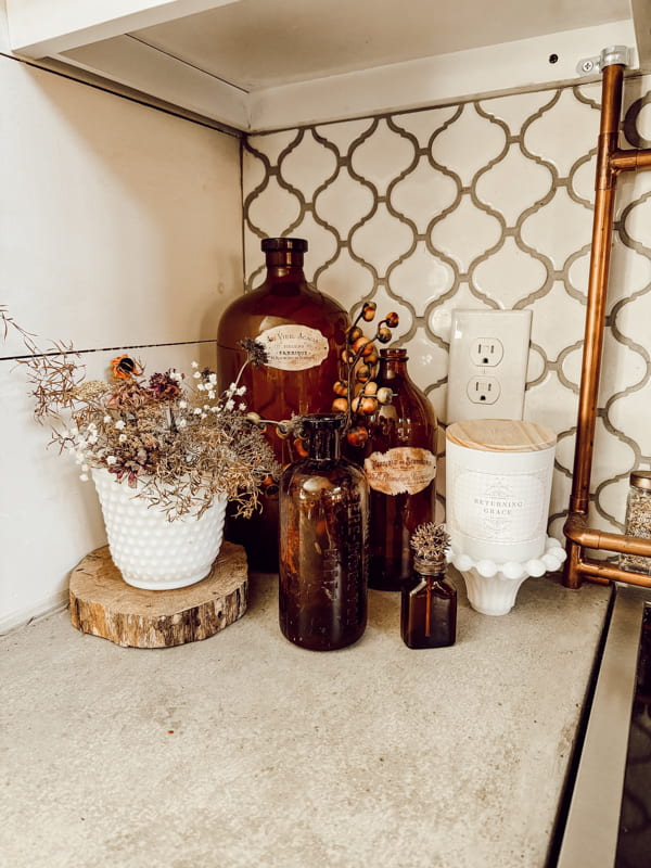 Fall vignette with vintage amber bottle and White milk glass for kitchen countertop vignette.