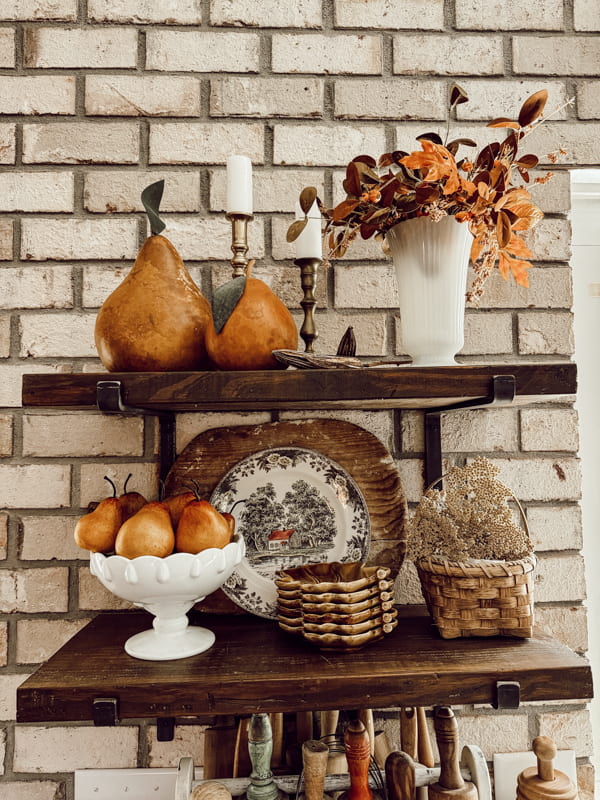 Decorate for Fall with vintage white milk glass on open kitchen shelves with pears, and faux fall stems.  