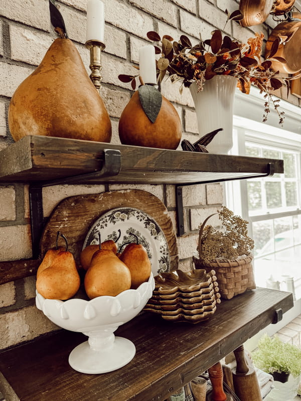 Open Kitchen shelves with bowl of pears and faux fall stems