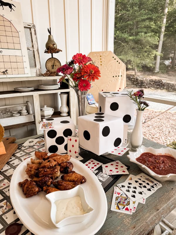 DiY Dice Centerpiece for Game Night Table Decoration with cards and fresh flowers.