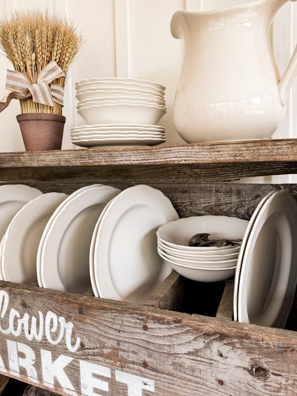 White Ironstone Vintage Dinnerware Sets displayed in an old flower box repurposed as a plate rack.  