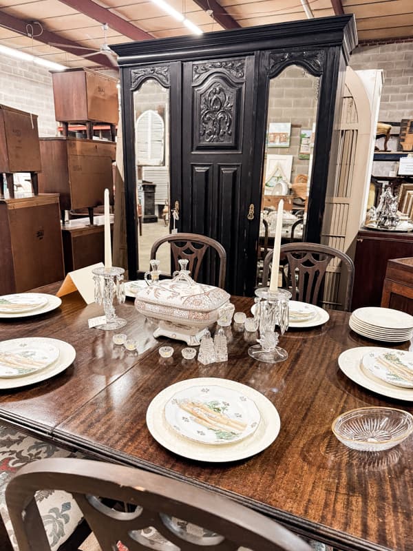 Legacy Salvage in Wilmington Vintage table and cabinets with old dishes  