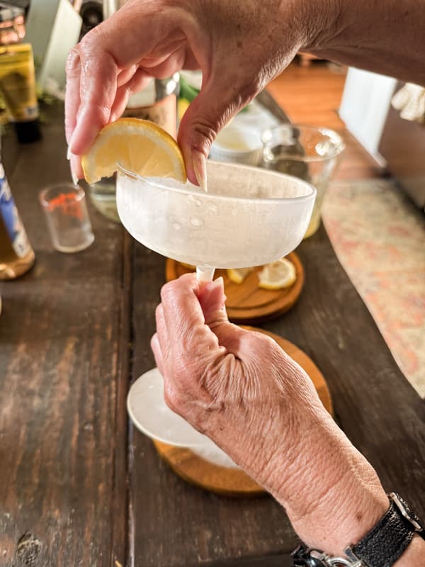 rub a lemon wedge around the rim of the martini glass to moisten before adding the sugar rim.