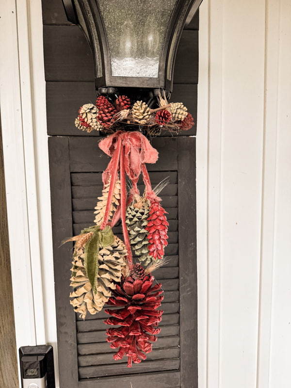 DIY Fall porch decor with an easy pinecone swag made with foraged pinecones and grapevine.