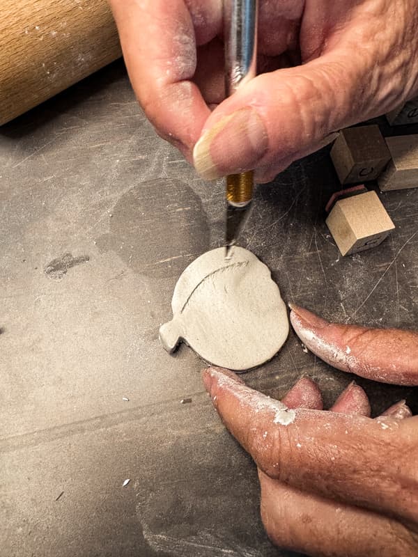 Carve details into the clay with a exacto knife