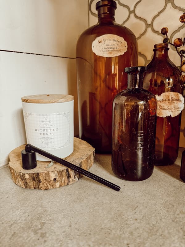 Returning Grace Signature Candle with vintage amber bottles 