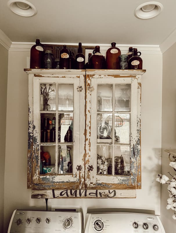 laundry cabinet does double duty to store vintage tableware.  