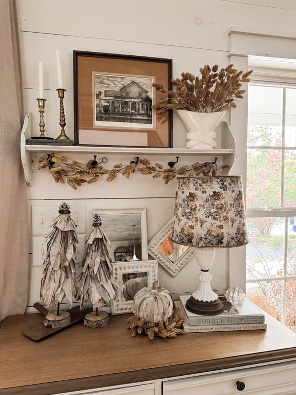 DIY Napkin Lampshade Makeover on entry table decorated for fall with corn husk DIY topiaries and pumpkin.  