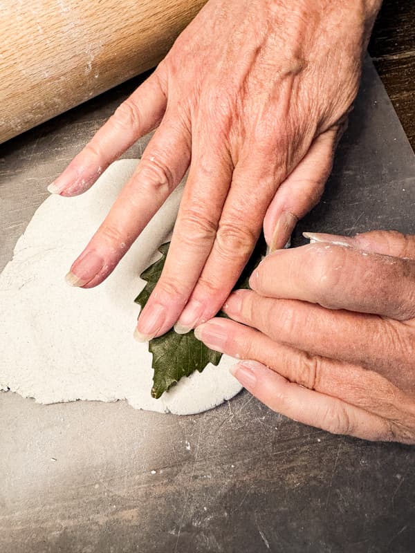 press a natural leaf into the air-dry clay form a pattern for the leaf shaped cheese markers