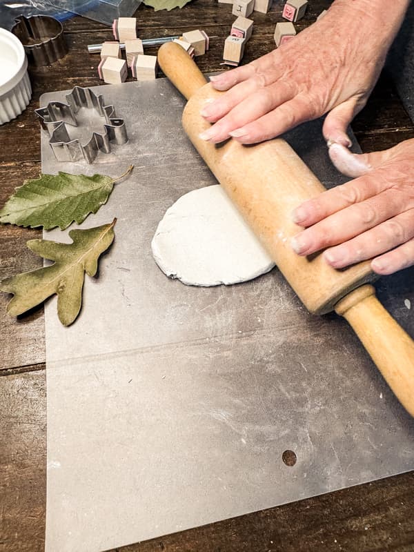 Roll air day clay with rolling pin.