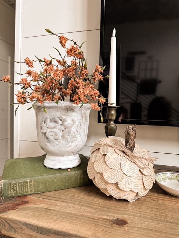 the upcycled decor vase with fall stems and a old book page DIY pumpkin on mantel