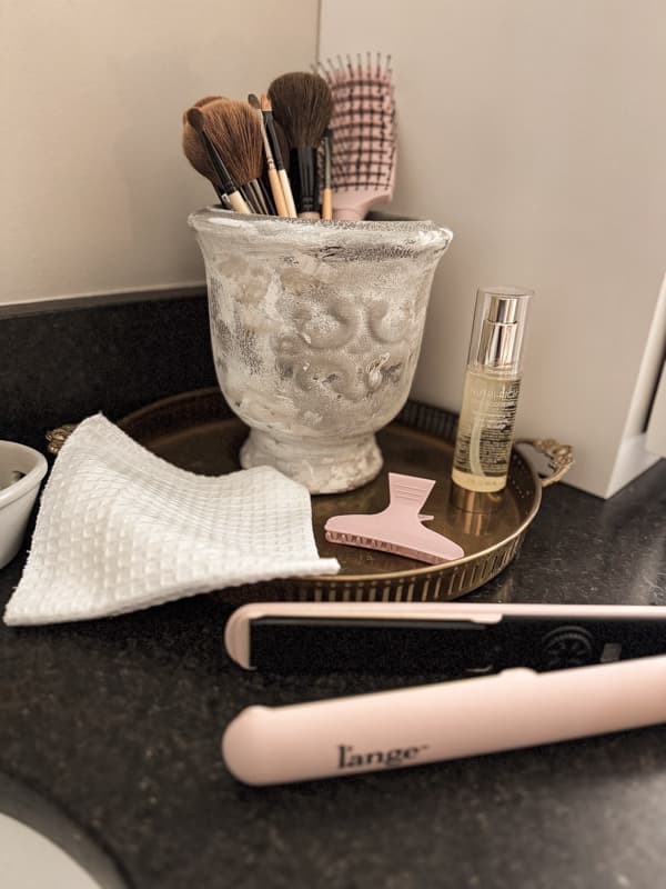 The DIY Decorative Vase makeover is perfect for holding hair supplies and makeup brushes in the bathroom