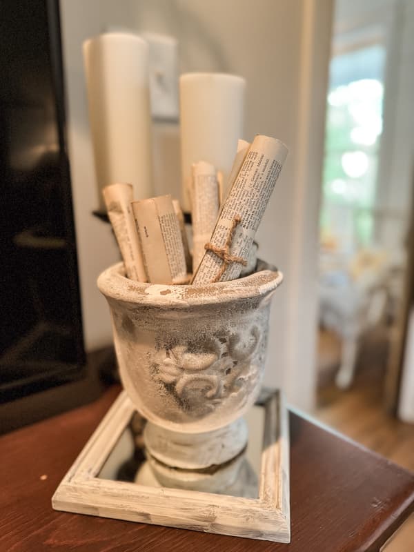 Decorative vase can hold old book pages rolled and tied with jute string.  