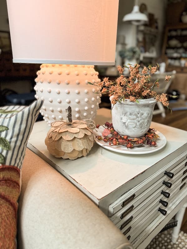 Side tables with DIY projects, upcycled thrift store vase makeover, old book page Dollar Tree pumpkin and hobnail thrifted lamp makeover