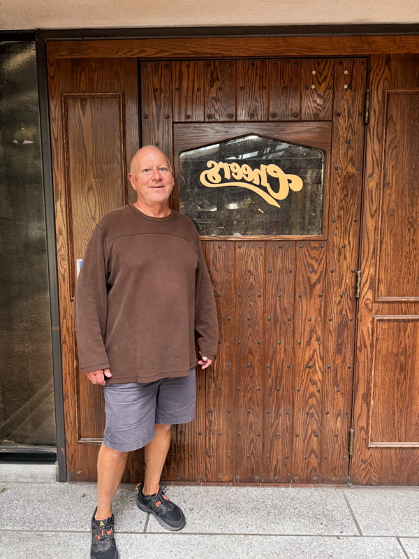 Brad at Cheers door in Faneuil Hall Marketplace in Boston MA