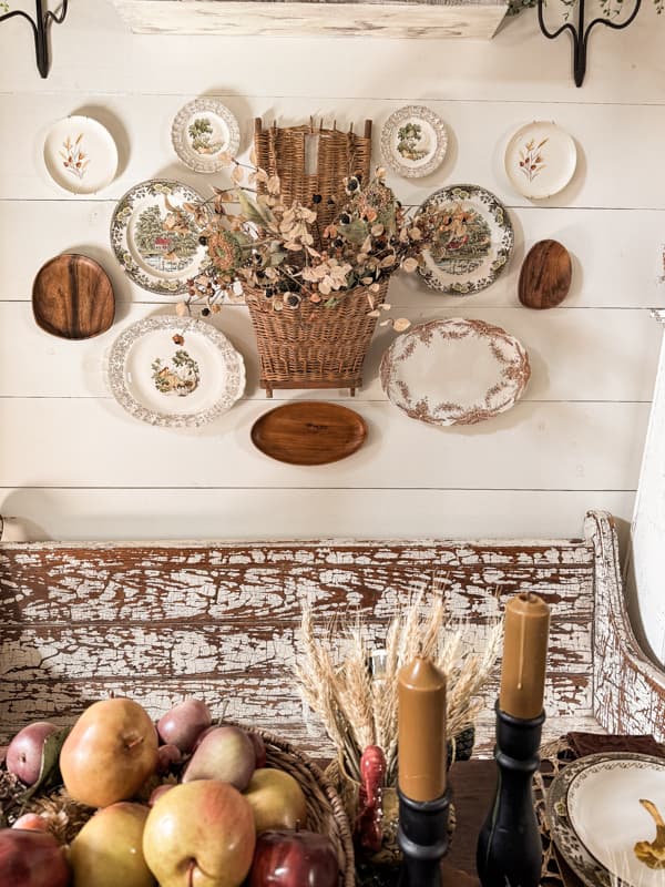 Fall Decorating Tips with wall hanging plate display in brown and white vintage transferfware dishes and gathering basket with fall stems.  