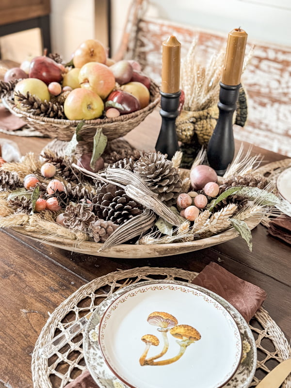 Dining table with mushroom plates, dried natural elements in dough bowl for Budget-Friendly Fall Decor ideas.  