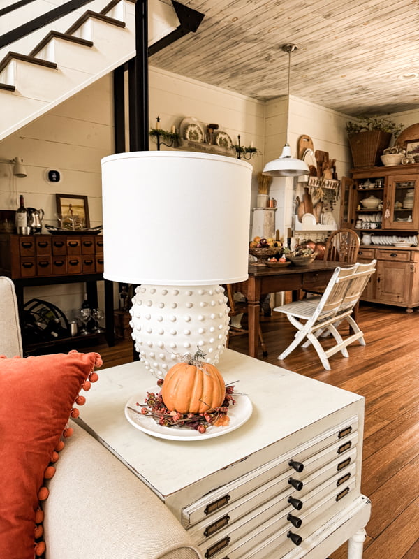 DIY hobnail lamp and pumpkin on repurposed side table in living room for fall home tour 2024