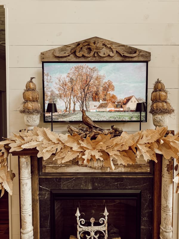 Fall mantel decorations with DIY fall mantel garland made from old book pages for rustic fall mantel ideas. 