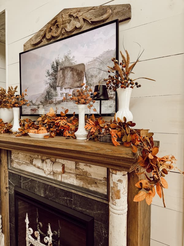 White Milk Glass vases for rustic fall mantel ideas with fall mantel garland and fall dried stems.