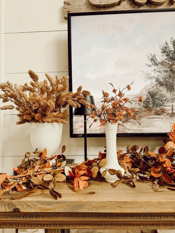 White Milk Glass for fall mantel decorations with fall mantel garland and fall dried stems. 