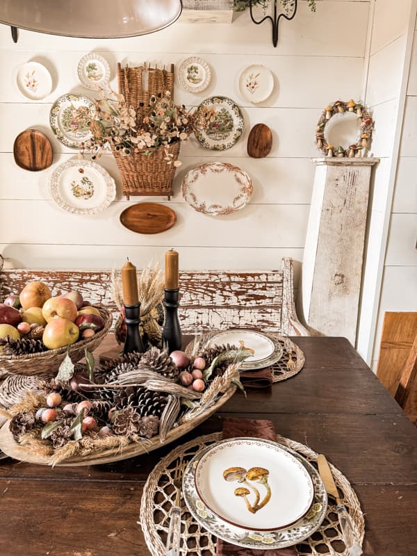 Dining table with mushroom plates, dried natural elements, and mushroom wreath for Fall Decorating tips.  