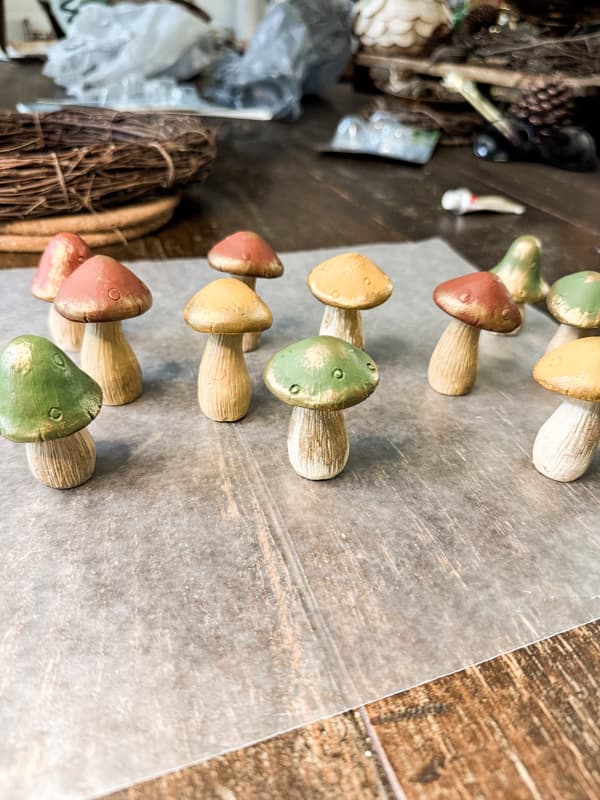 Painted Dollar Tree Mushrooms in green, gold, and rust. with gold touches using rub n buff.  