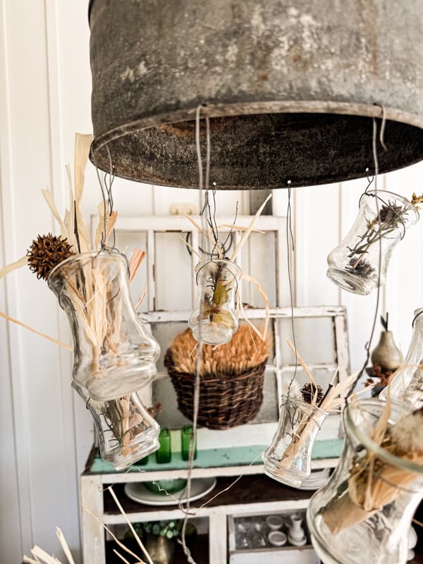 DIY light fixture made from a tractor funnel and thrift store jar for hanging vases