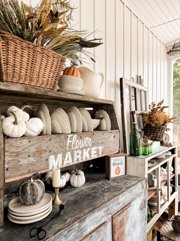 Vintage Ice Box with ironstone dishes and fall basket arrangement for Fall Screened in porch Autumn Tour