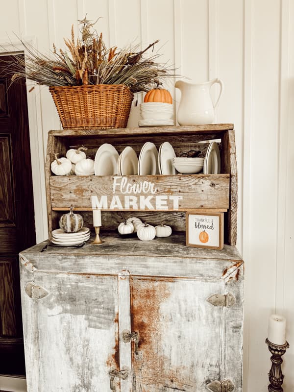 Vintage Ice Box with ironstone dishes and fall basket arrangement for Fall Screened in porch Autumn Tour