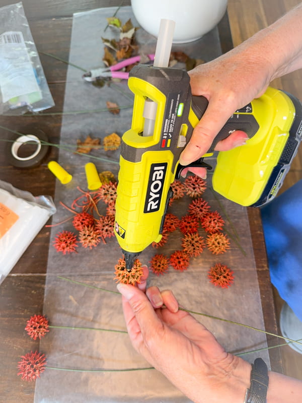 Add hot glue to sweet gum balls to make a fall stem.  