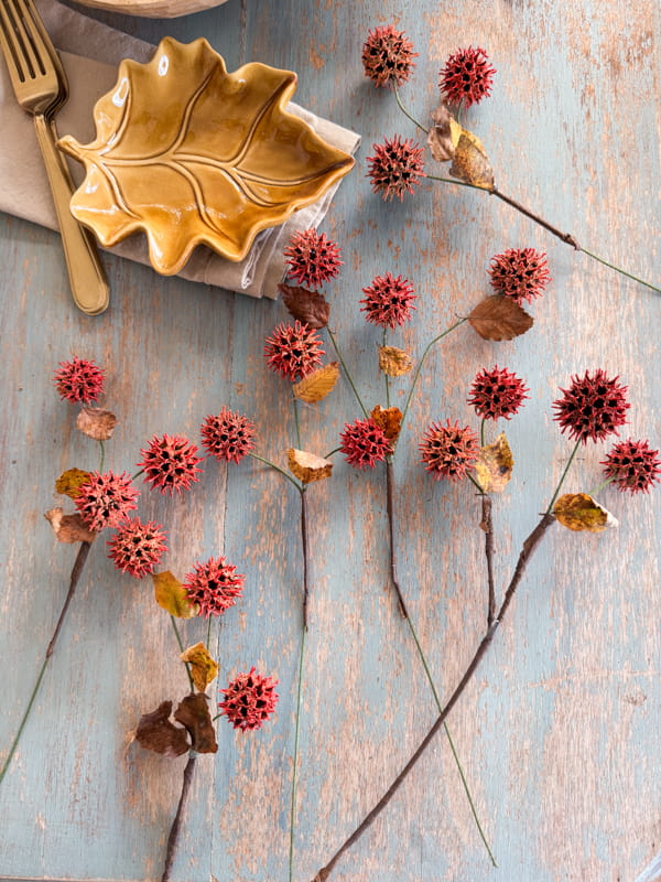 Foraged Sweet Gum Ball Stems painted with spray. paint. Scavenge for free elements.