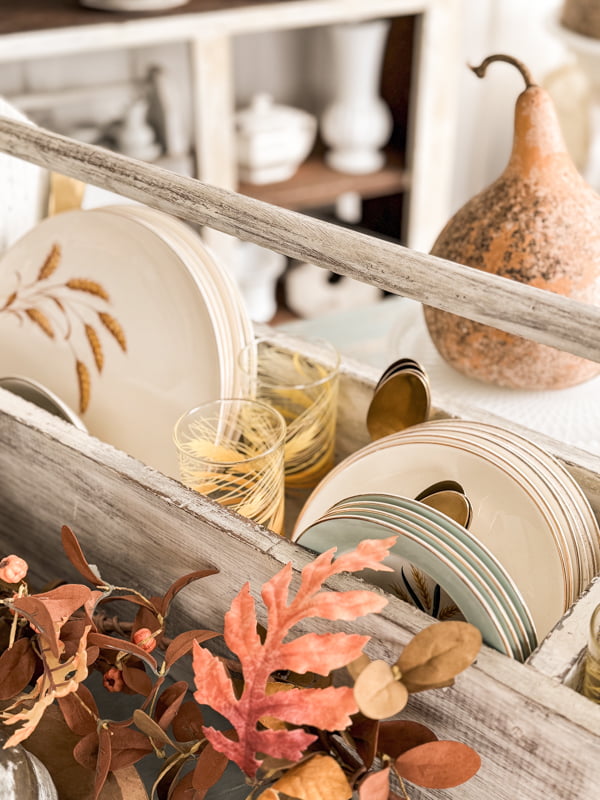 Toolbox with Golden Wheat Vintage Dishes and glassware on Fall porch table.  