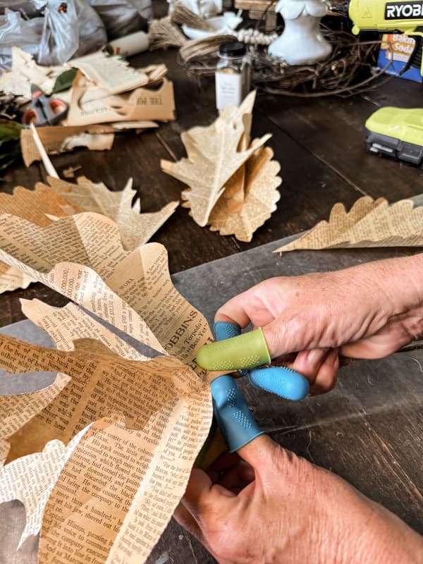 Twist stems of old book page leaves onto a twine wire.  