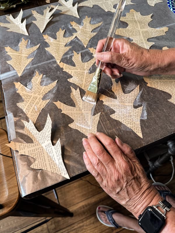 Paint the leaves with mod podge and allow to dry.