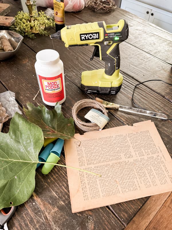 Supplies for DIY Fall Leaf Garland made with old book pages, mod podge and hot glue.