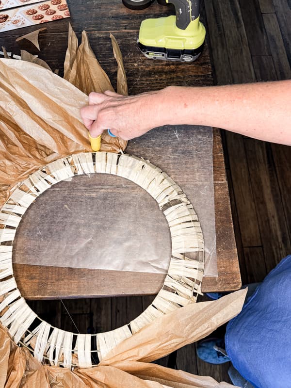 Hot glue bundles of faux corn stalk leaves to wreath frame. 