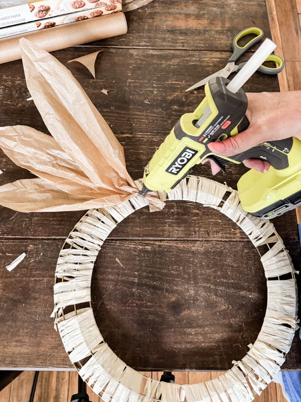 Hot glue bundles of faux corn stalk leaves to wreath frame. 