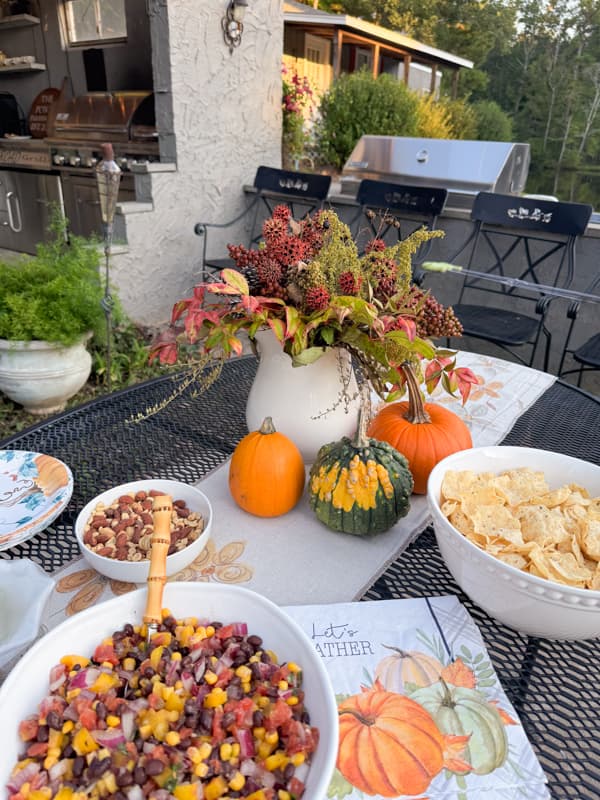 Appetizer table with foraged fall floral arrangement. with sweet gum ball stems.  