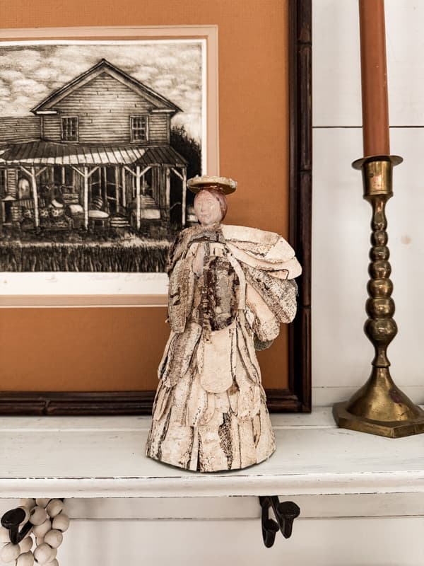 Birch Bark Christmas Angel on shelve with print and vintage brass candlestick