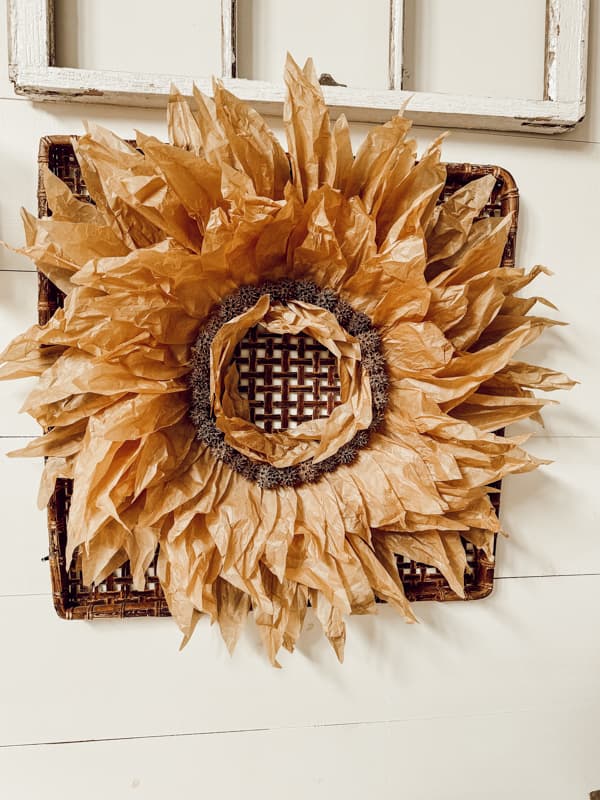 DIY Corn Husk Wreath with sweet gum balls on wall basket