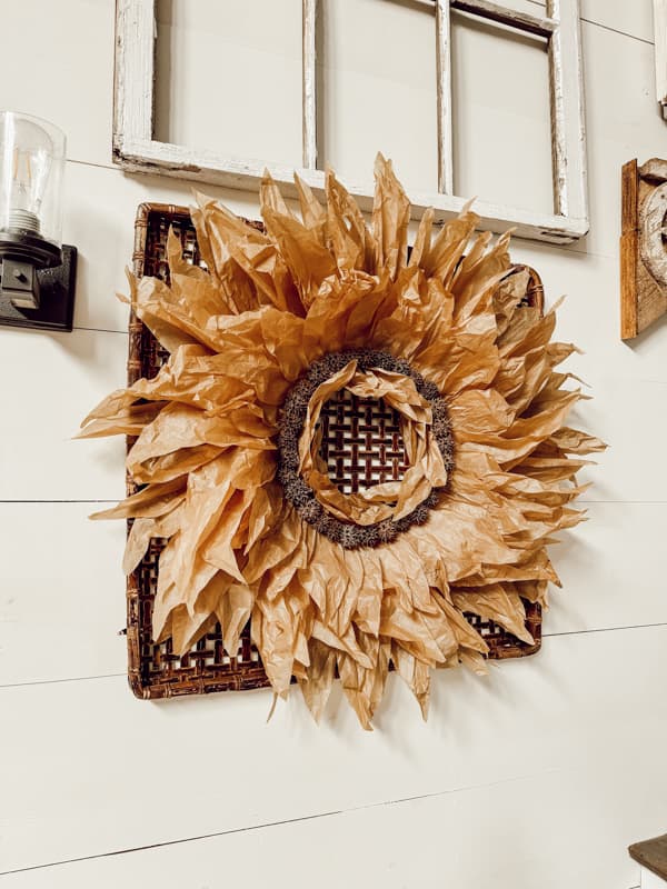 DIY Corn Husk Wreath with sweet gum balls on wall basket