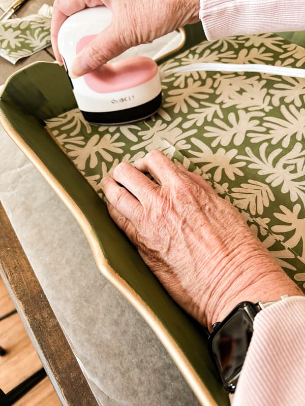 Use mini heat press to adhere the napkin to the bottom of the decorative tray.