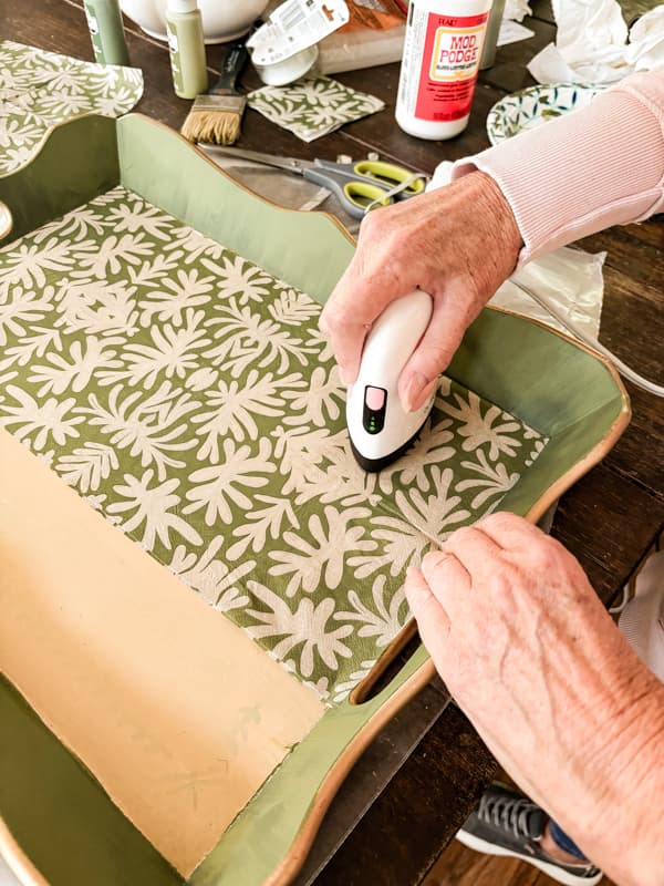 Use mini heat press to adhere the napkin to the bottom of the decorative tray.