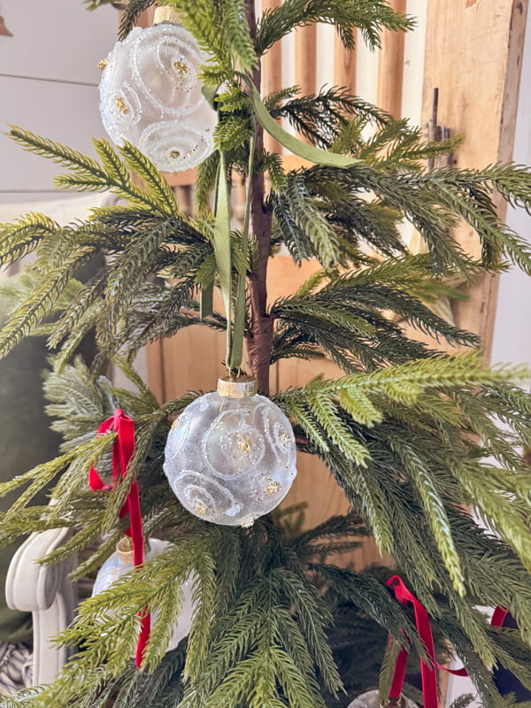 Small Christmas Tree with DIY Christmas Ornaments with hot glue and glitter.