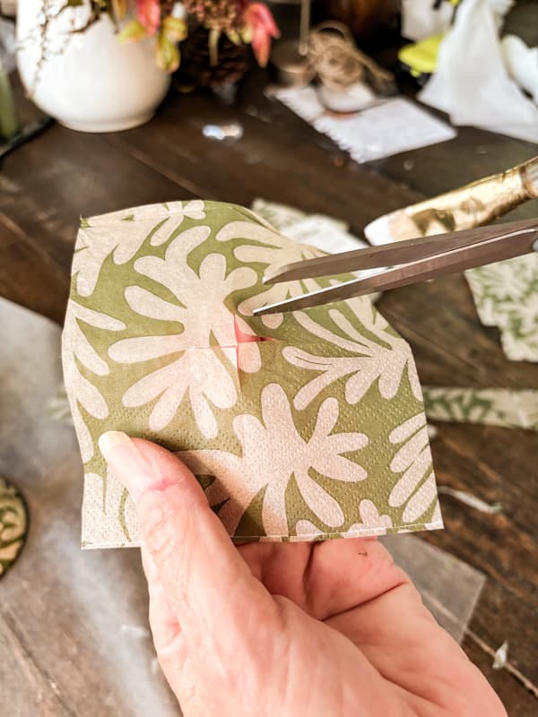 Cut decoupage Christmas paper Napkin into pieces for craft update.