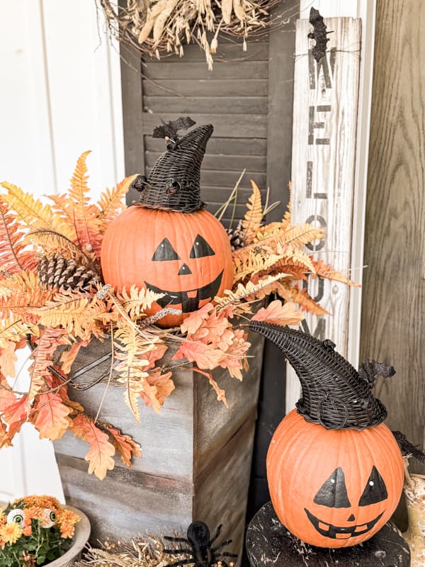 DIY painted pumpkins for no crave Jack O'Llanterns on front porch decorated for Halloween on a budget.  