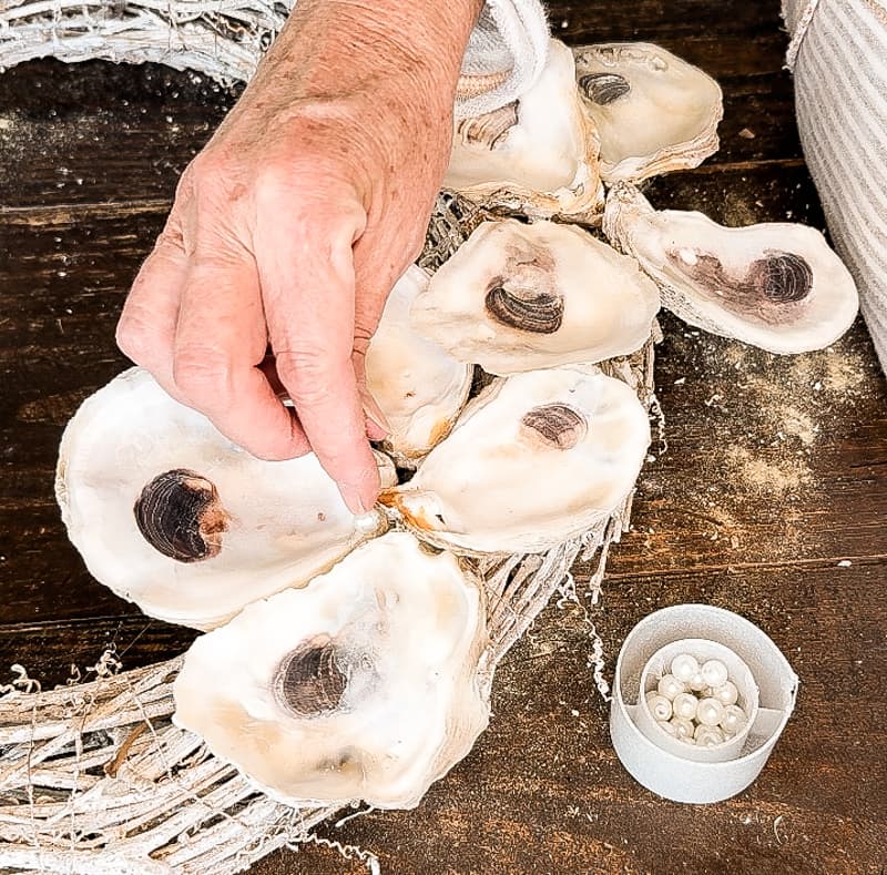 add pearls to oyster shell wreath