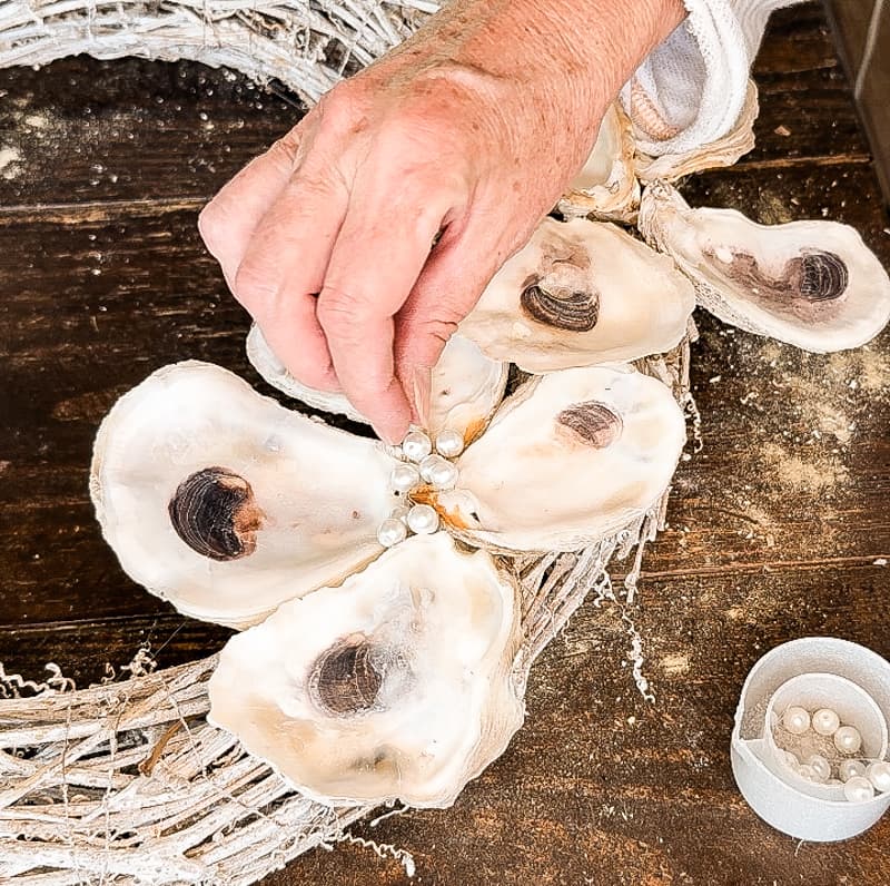 add faux pearl beads to centers of the oyster shells